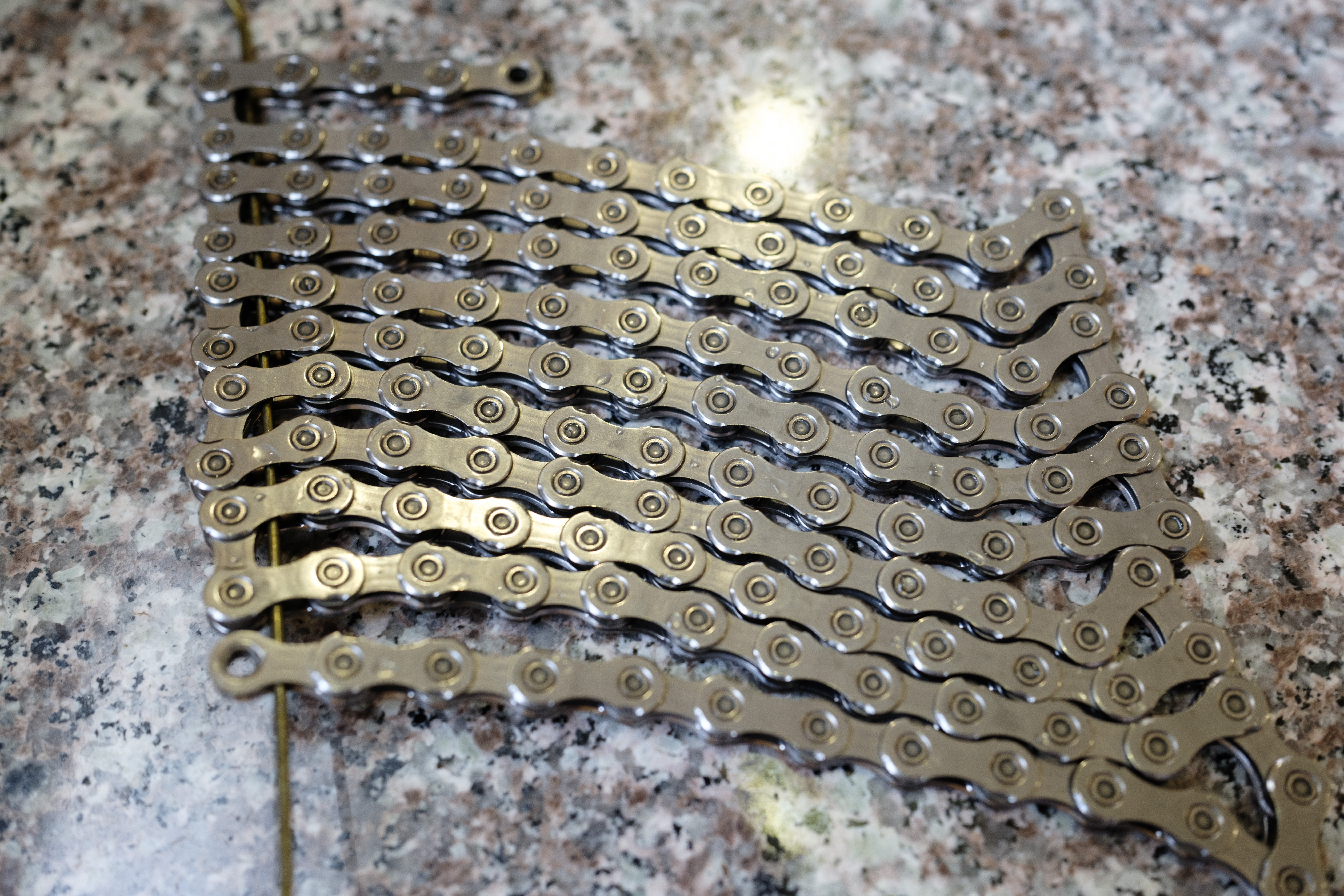 A clothes hanger fit through the links of a chain