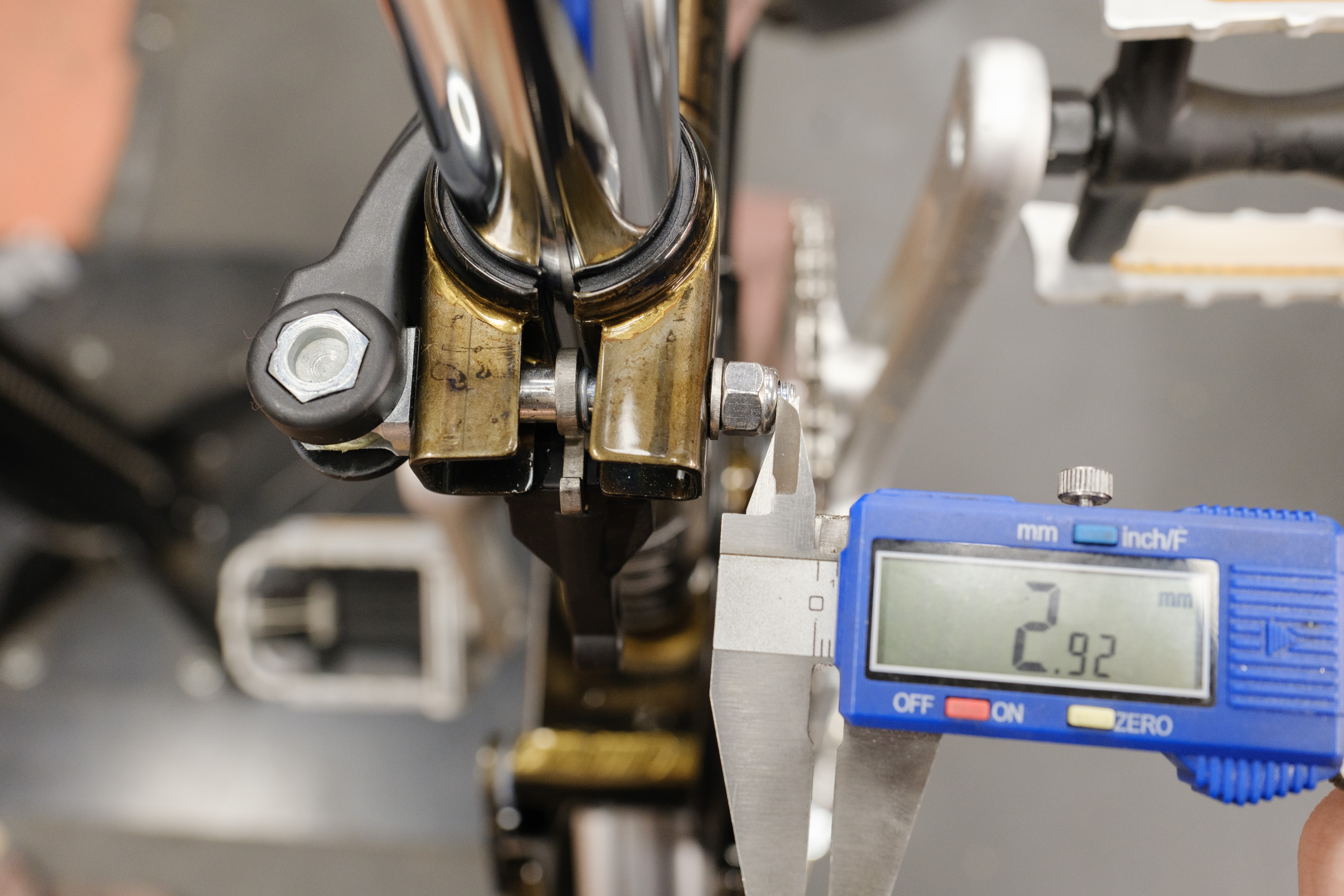 Calipers reading 2.92mm on the exposed bolt past the quick release nut.