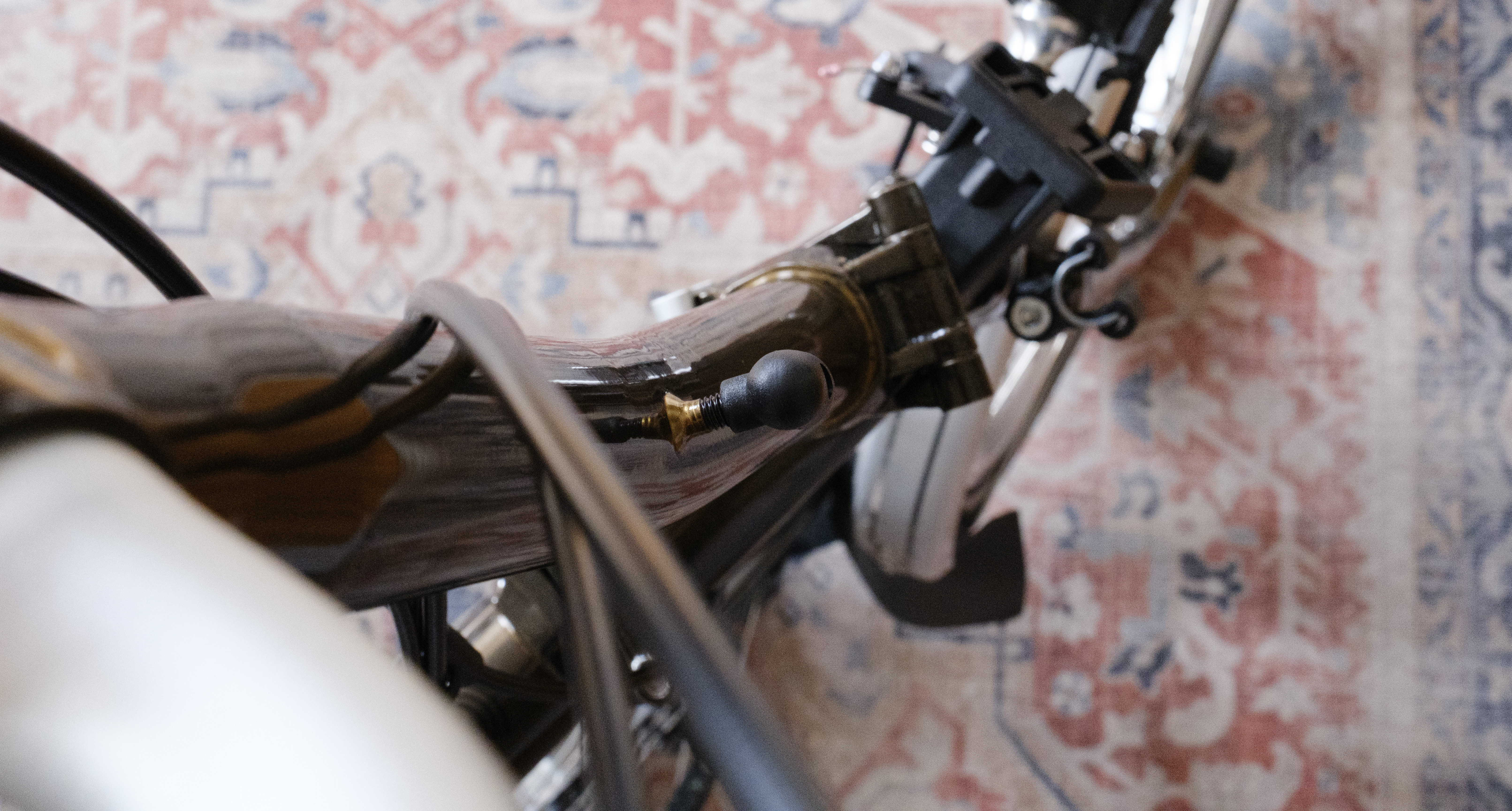 The black handlebar catch nipple screwed on to a bolt brazed on to the stem.