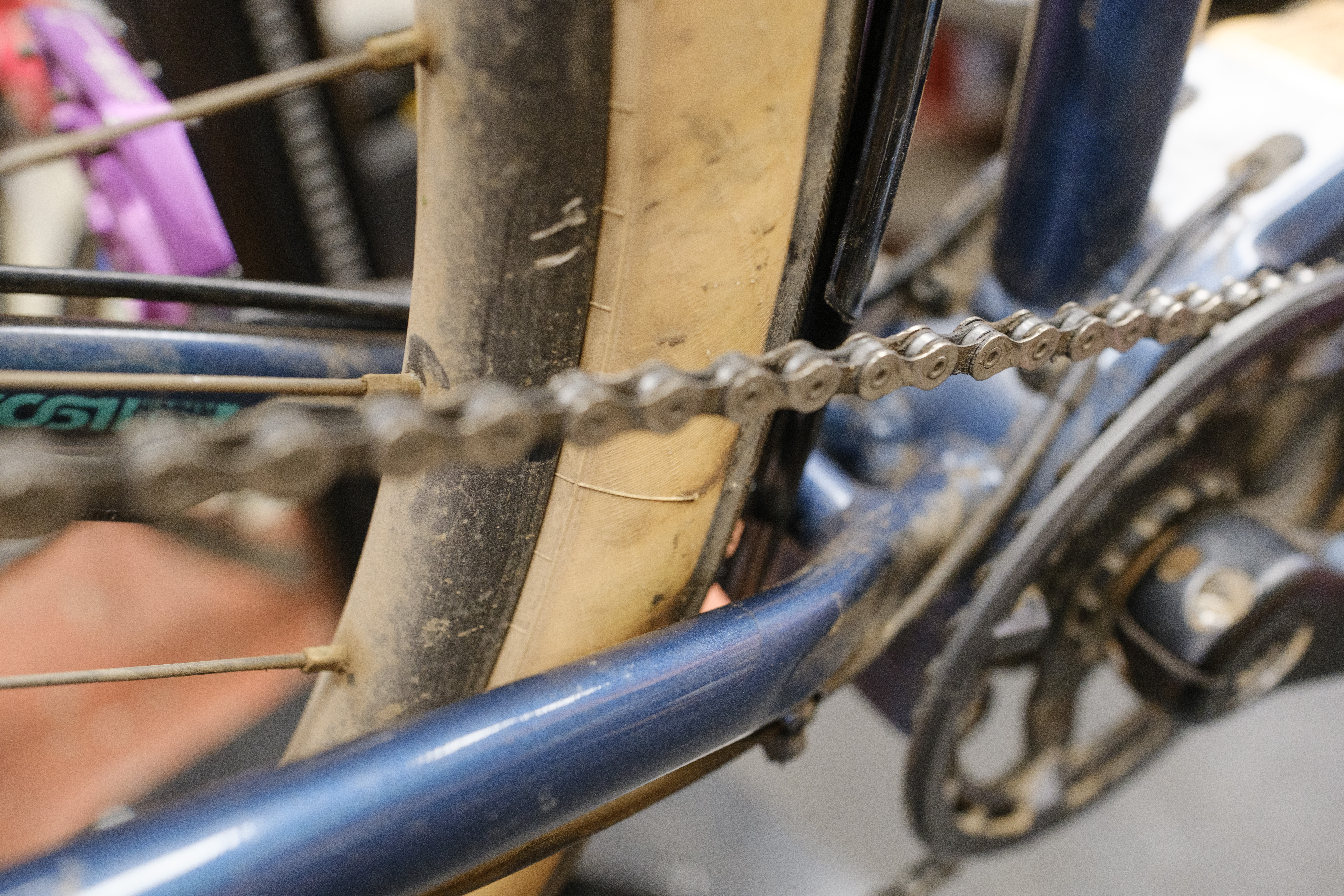 A close up of a few millimeters of clearance between the tire and fender above the chainstay bridge