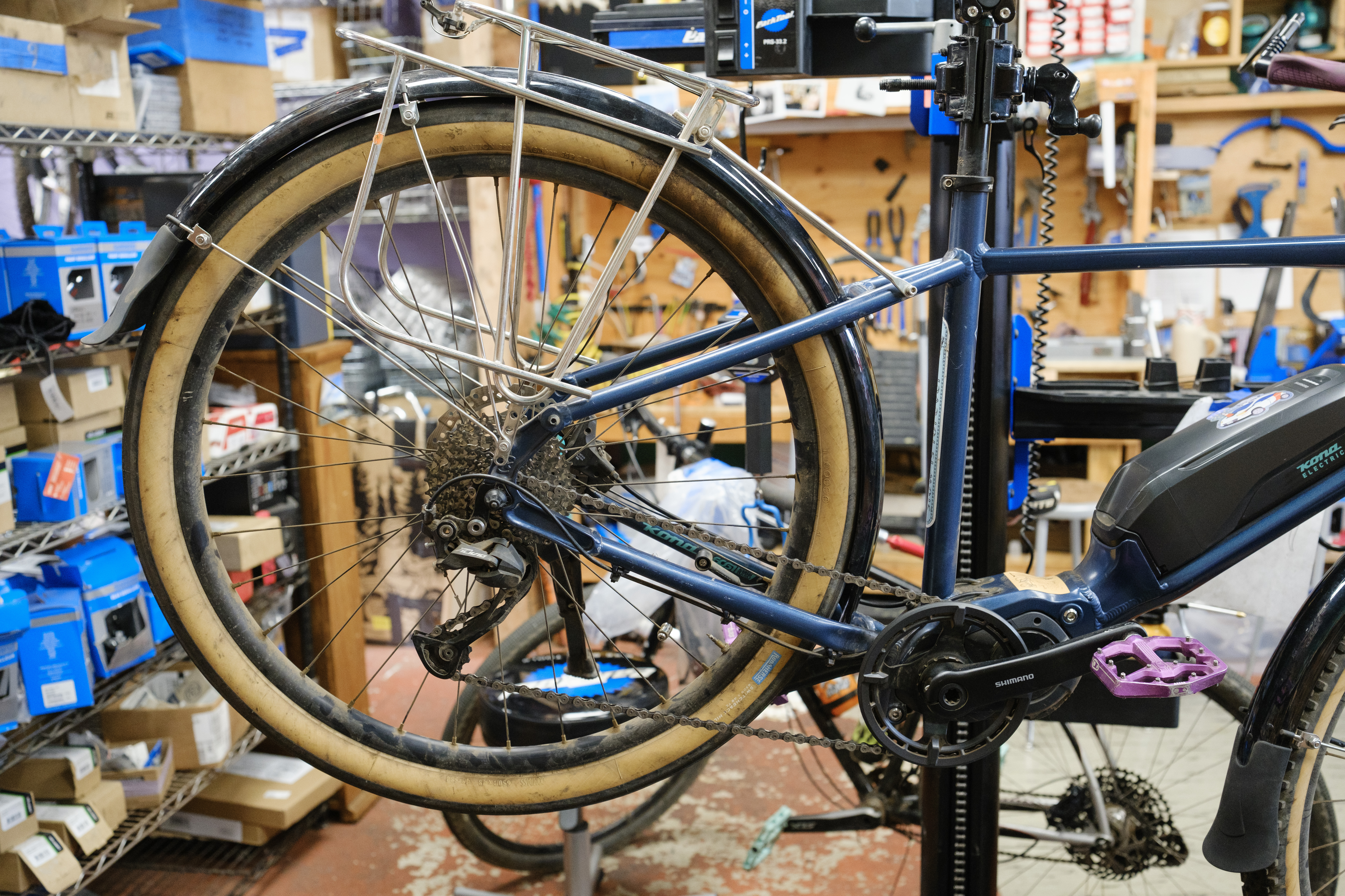 The rear of a blue bike showing a black fender being setup