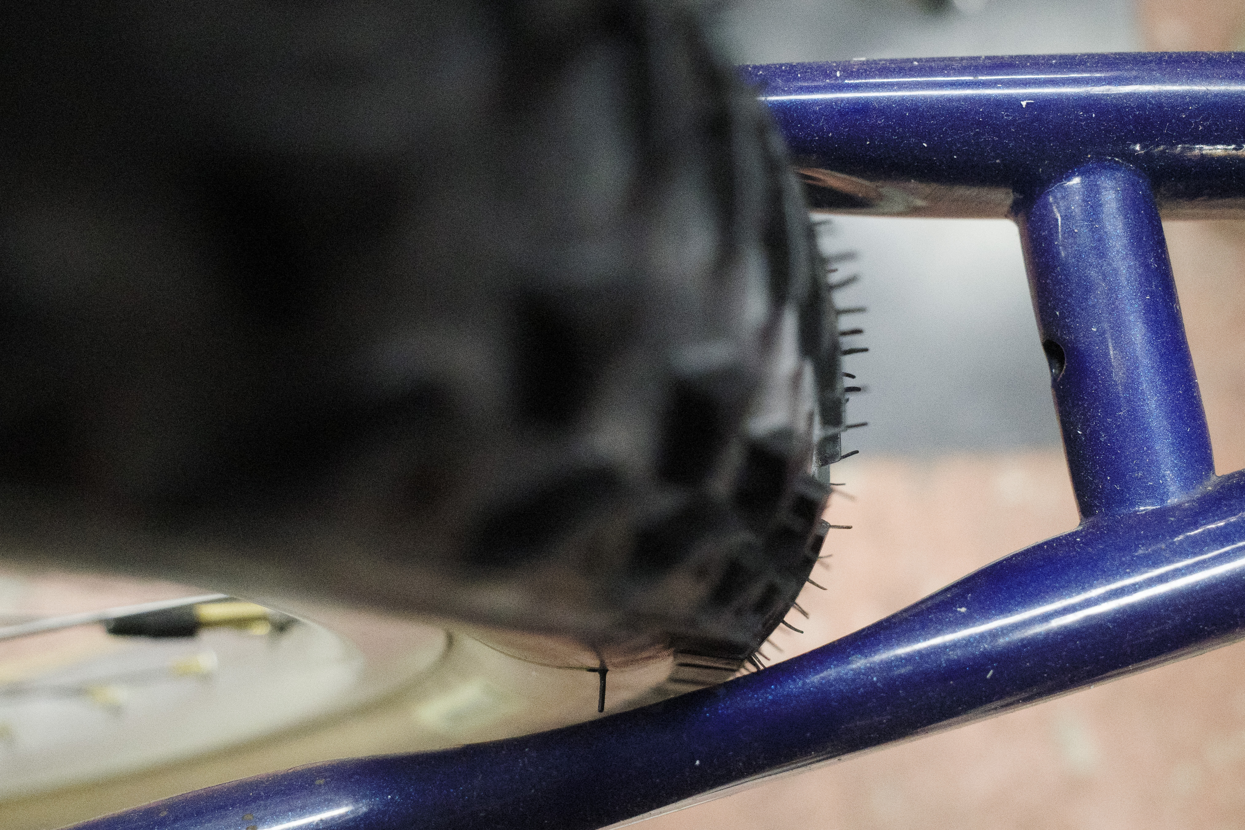 Close up of the tire next to the drive side chainstay showing very little tire clearance