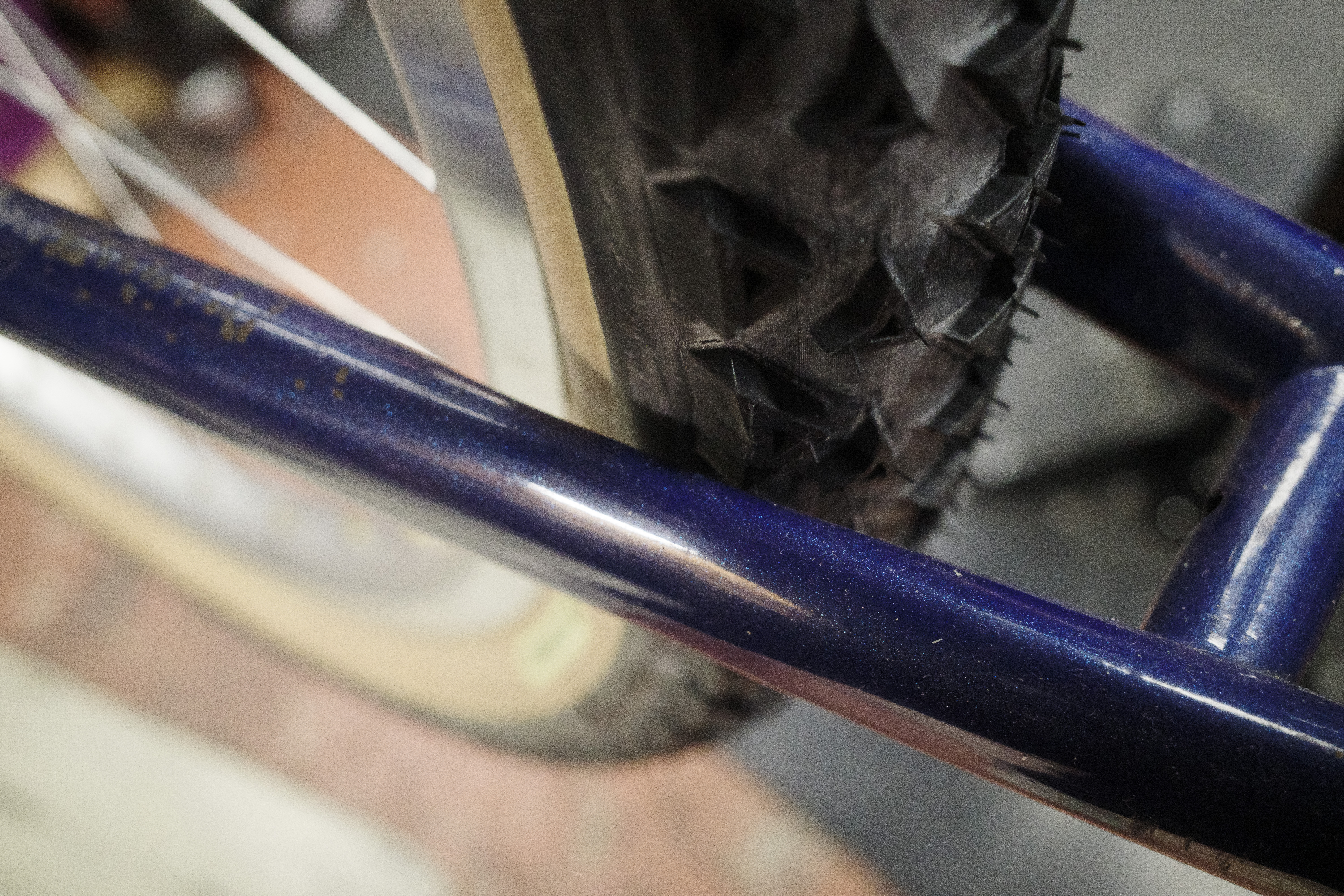 Triangular knobs on a tire inside a metallic blue rear triangle