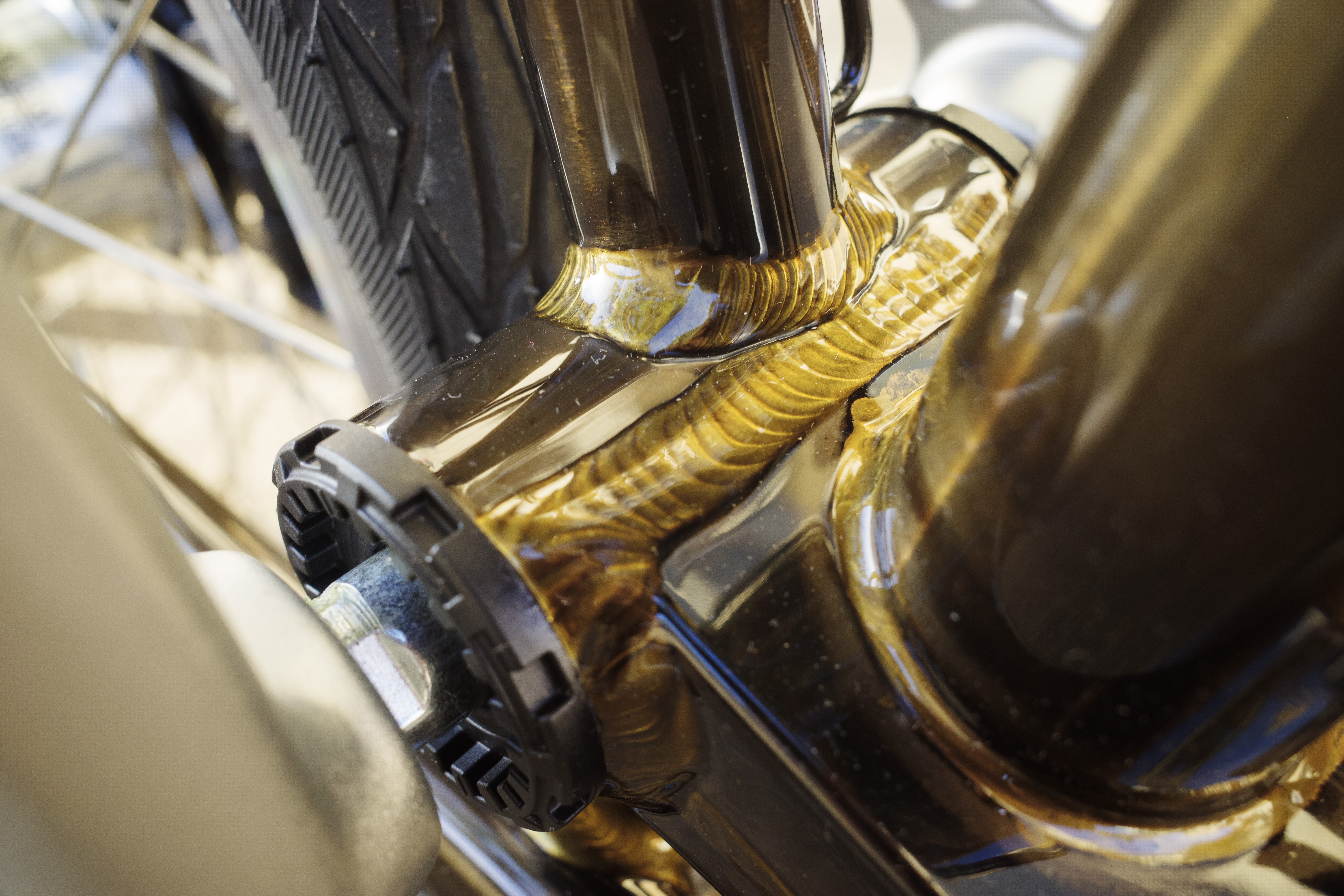 The brazing showing through the transparent lacquered finish over the bottom bracket shell.