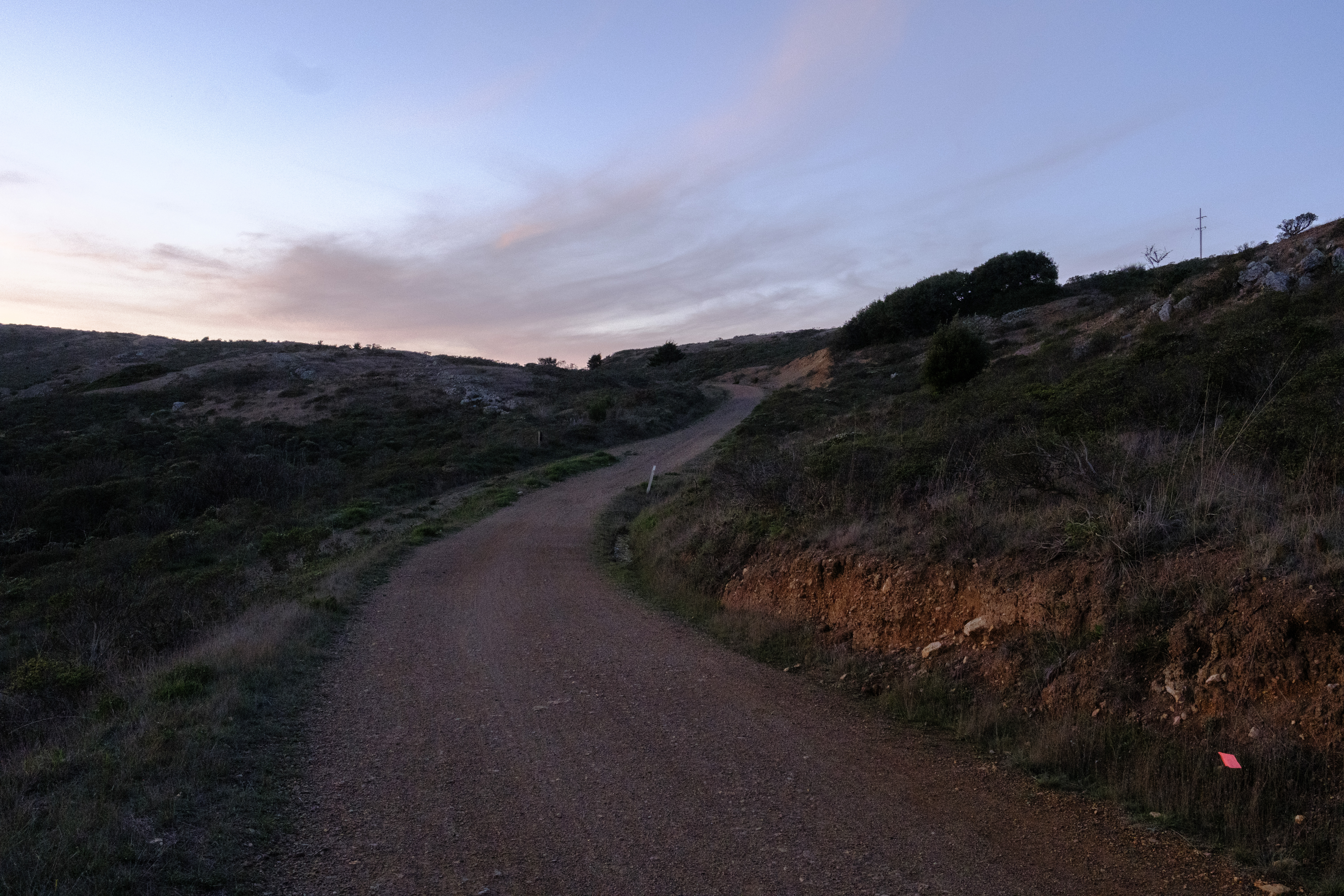 A dim trail with the sunset in the background