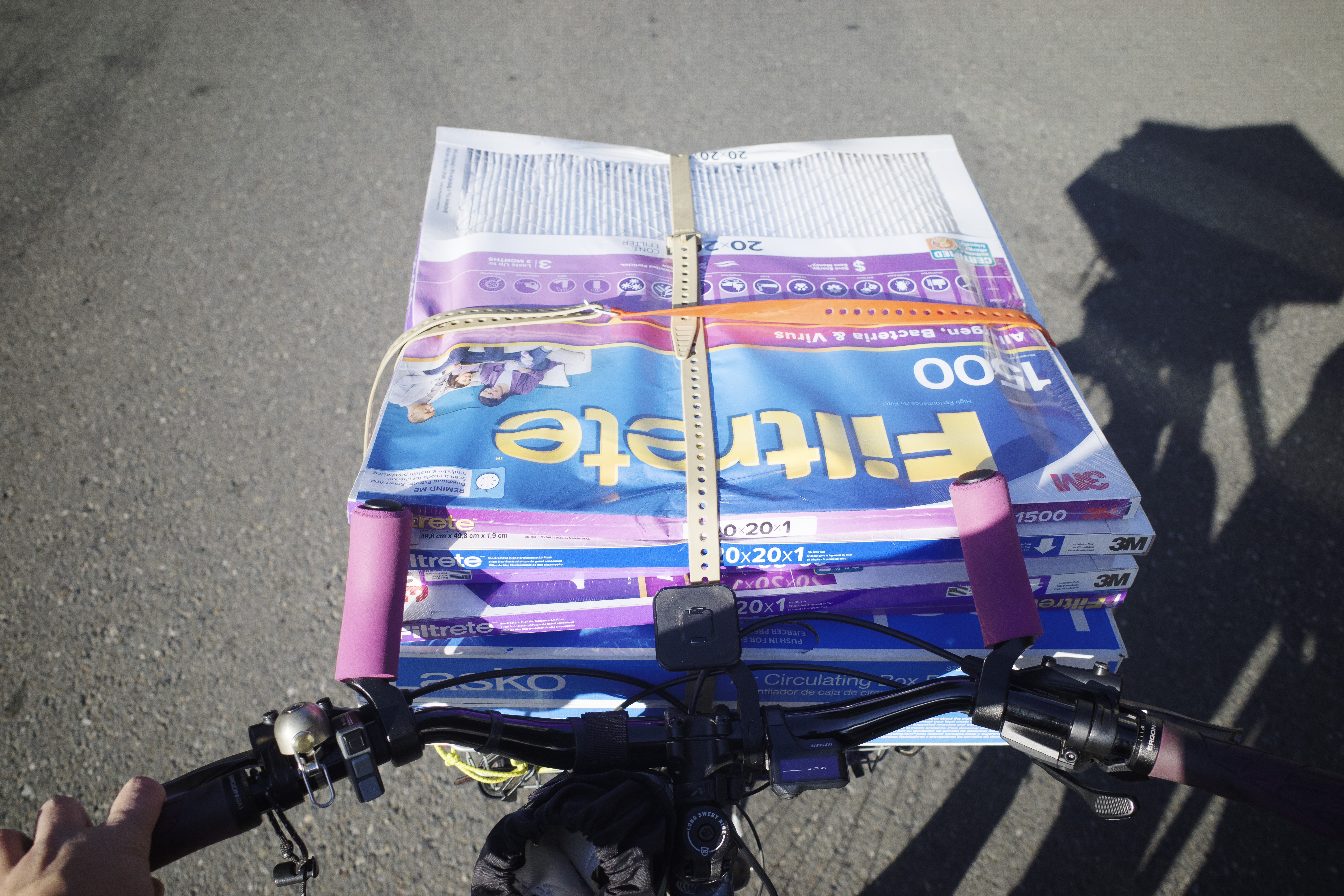 Looking at my bike handlebars with a stack of 3M filters on the basket