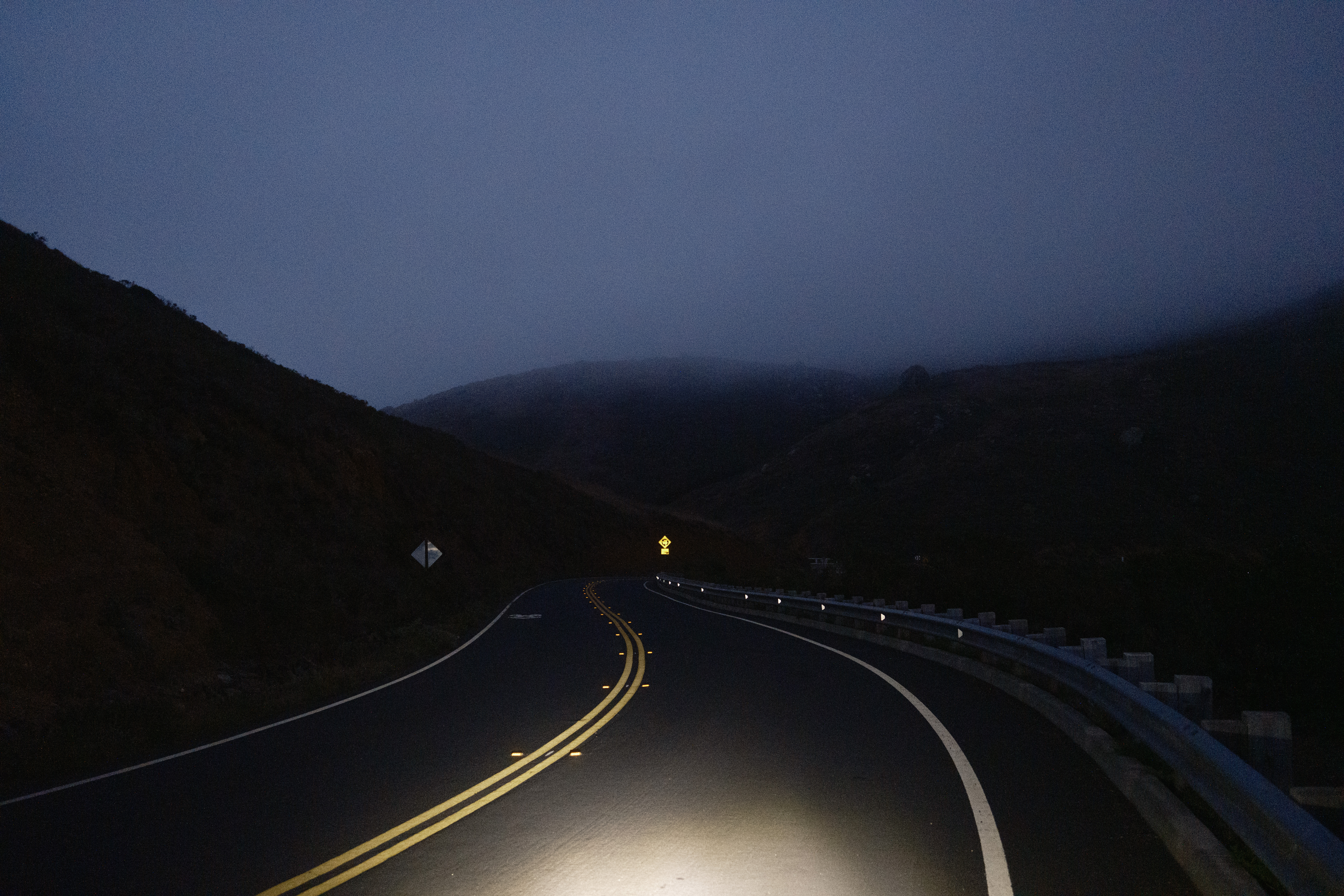 Conzelman Rd in the dark facing fogged over hills