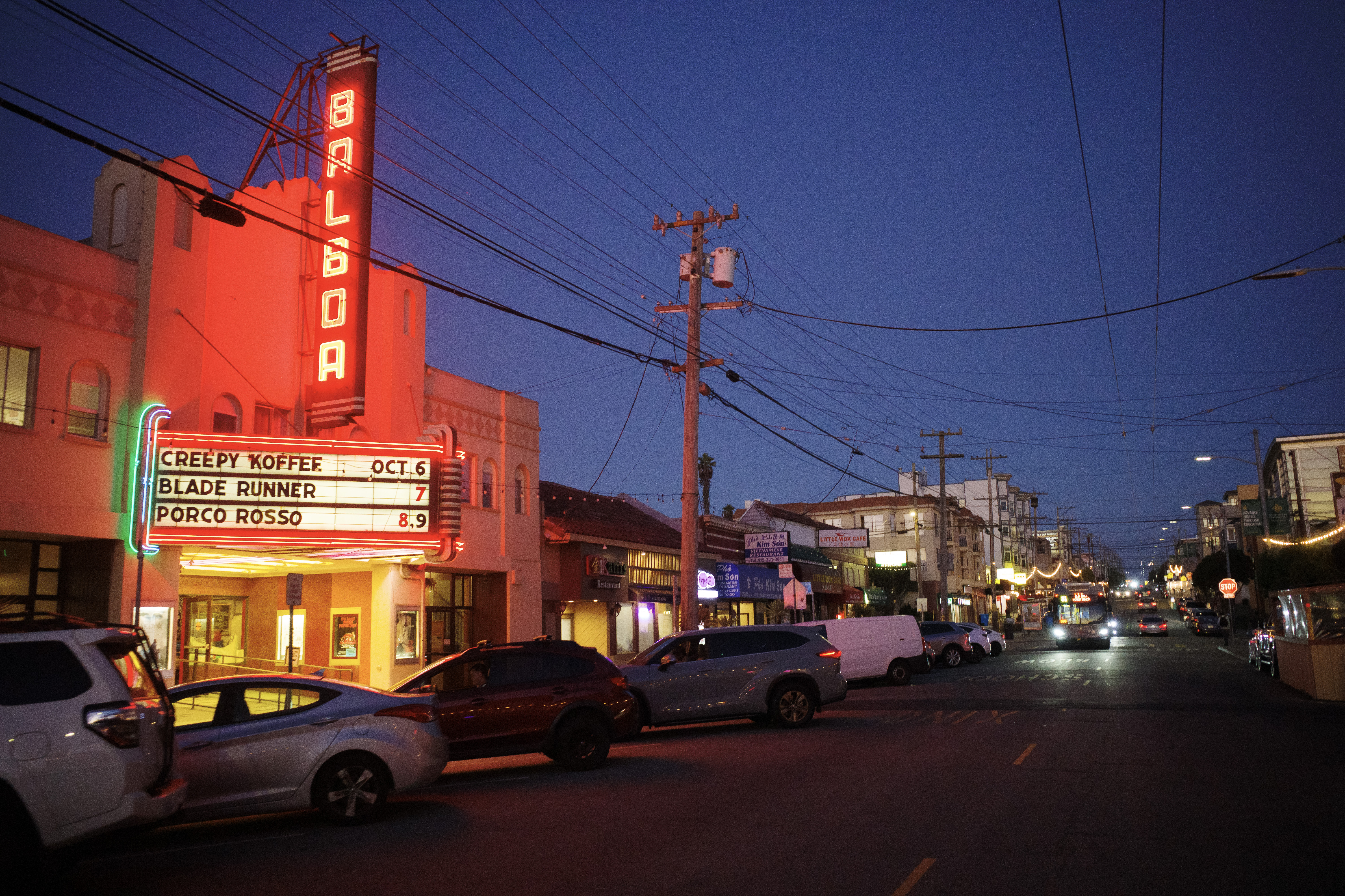 The marquee of the Balboa Theater with the 31 Balboa bus coming down the street.