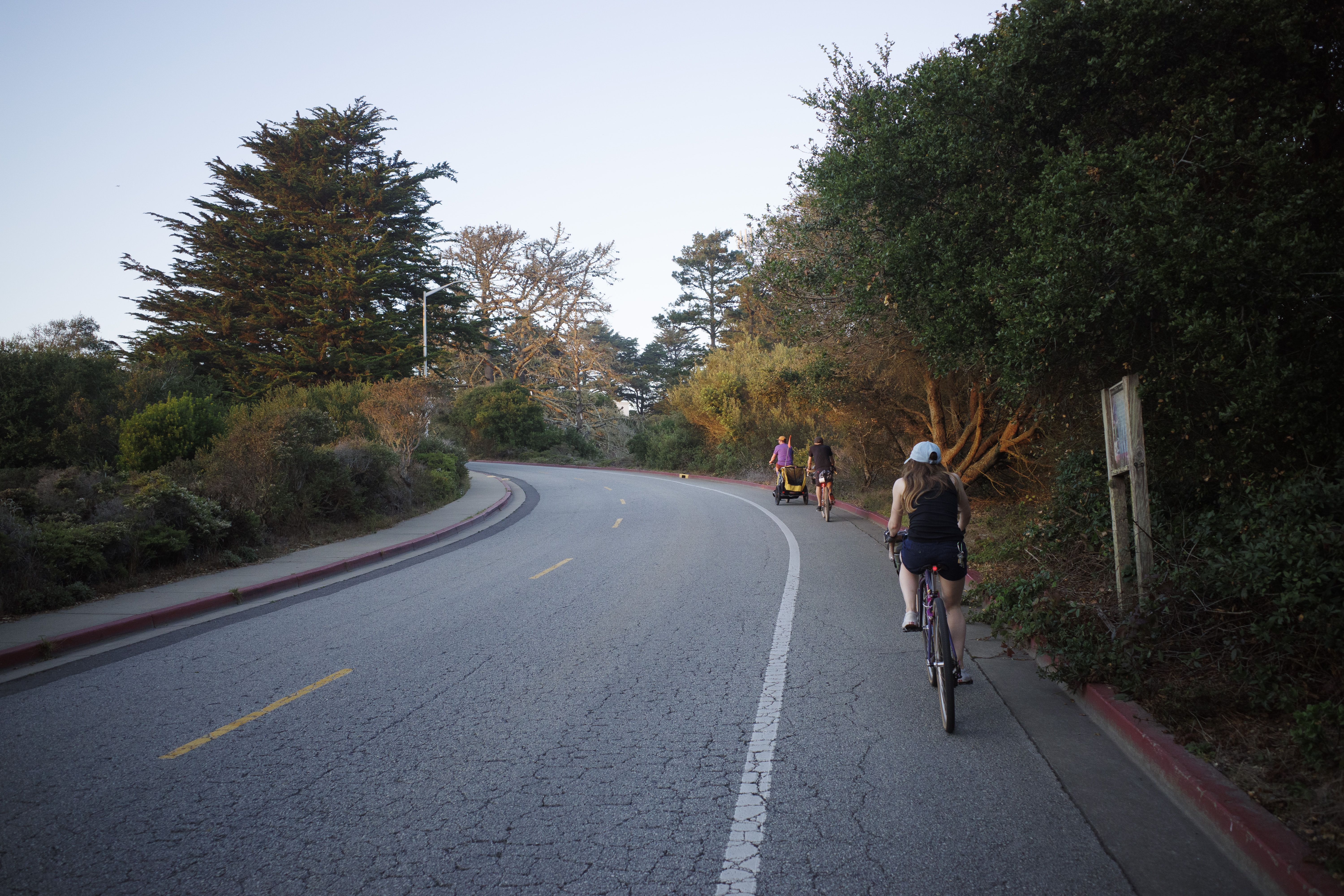 Jerry, Ben, and Kat climbing up Battery Caulfield in the golden hour glow