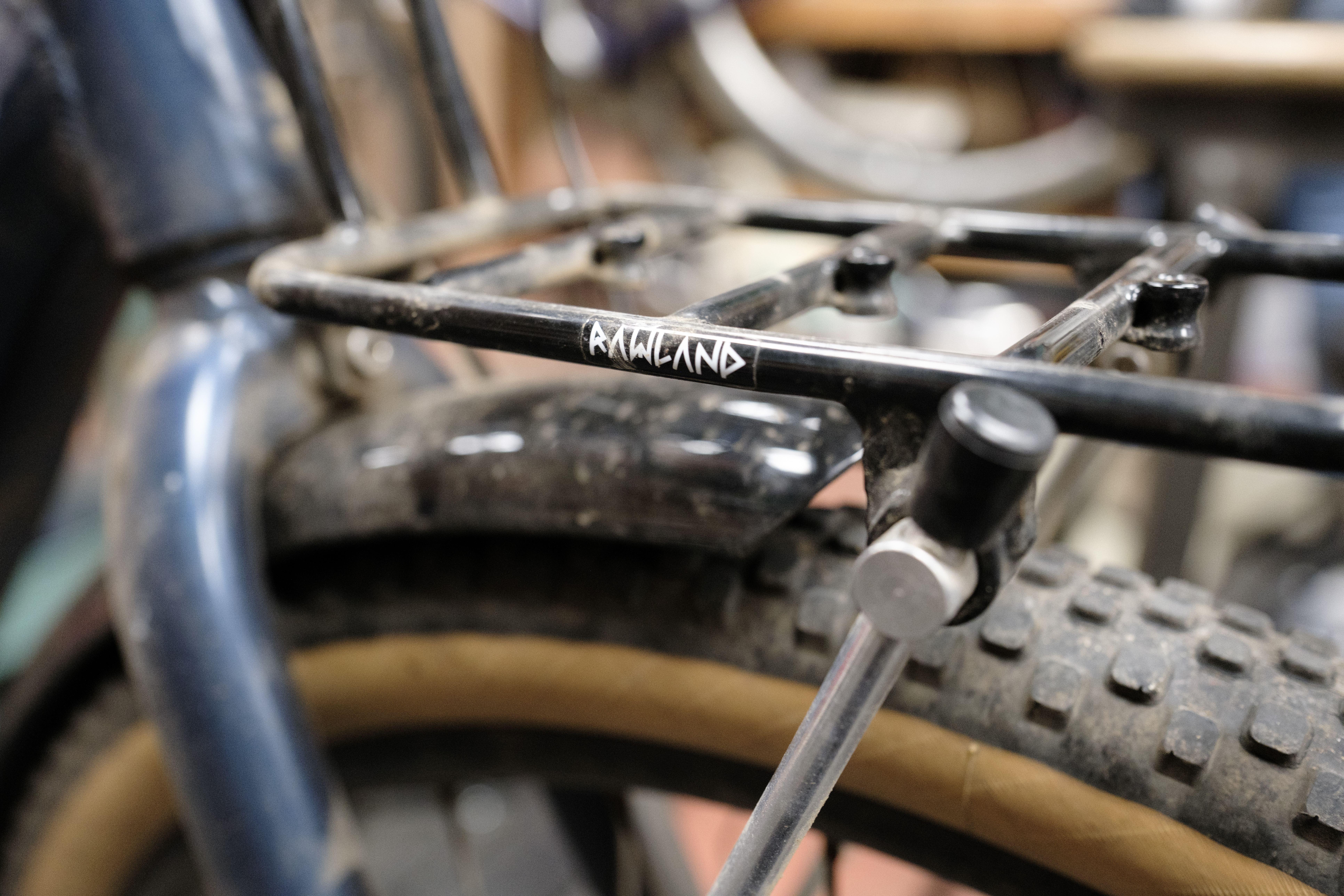 A close-up of a 'Rawland' decal on a black rack.
