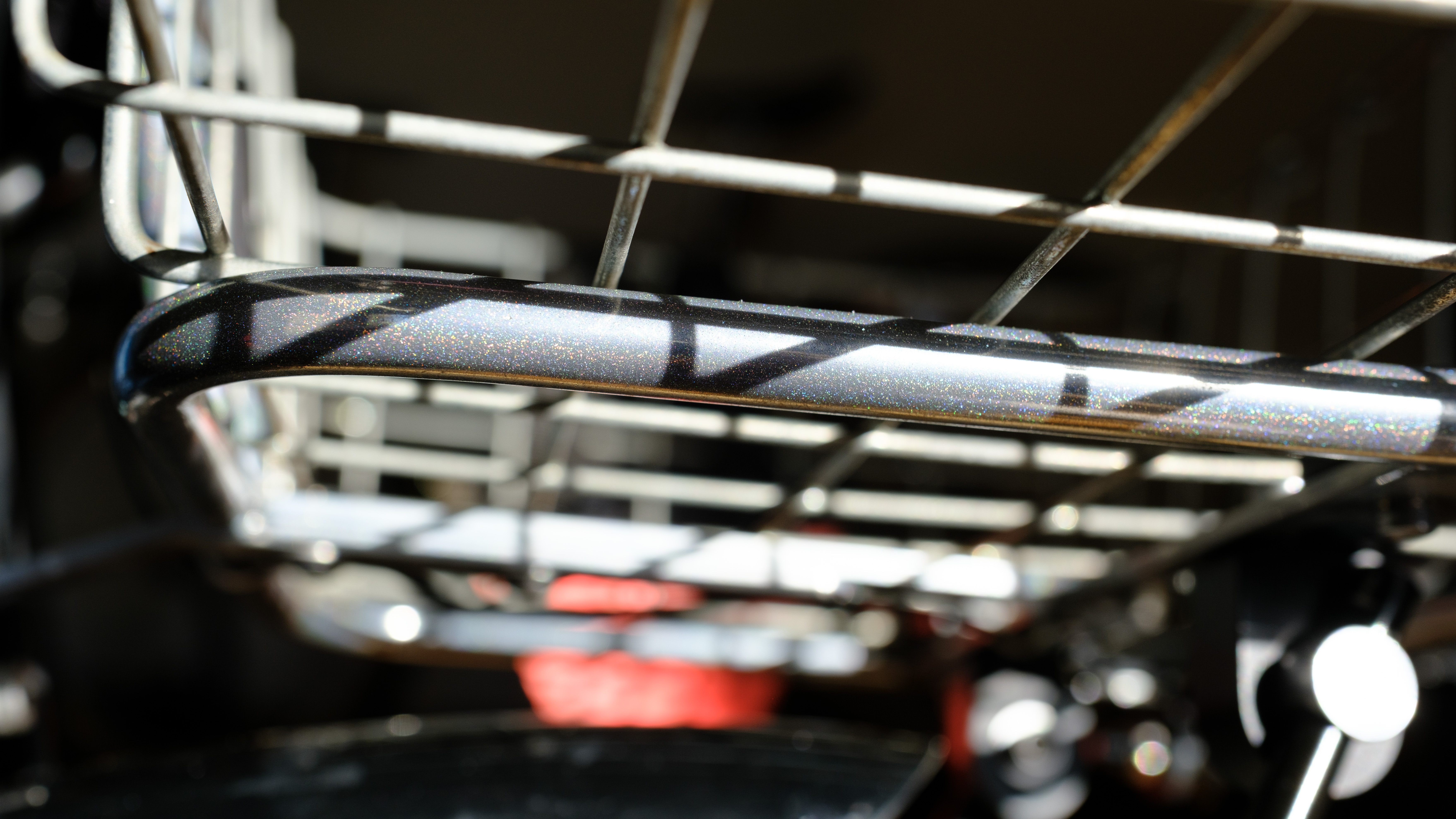 A close-up of the tubing on a RIP Rack in GSC Rainbow Chrome with rainbow sparkles glistening.