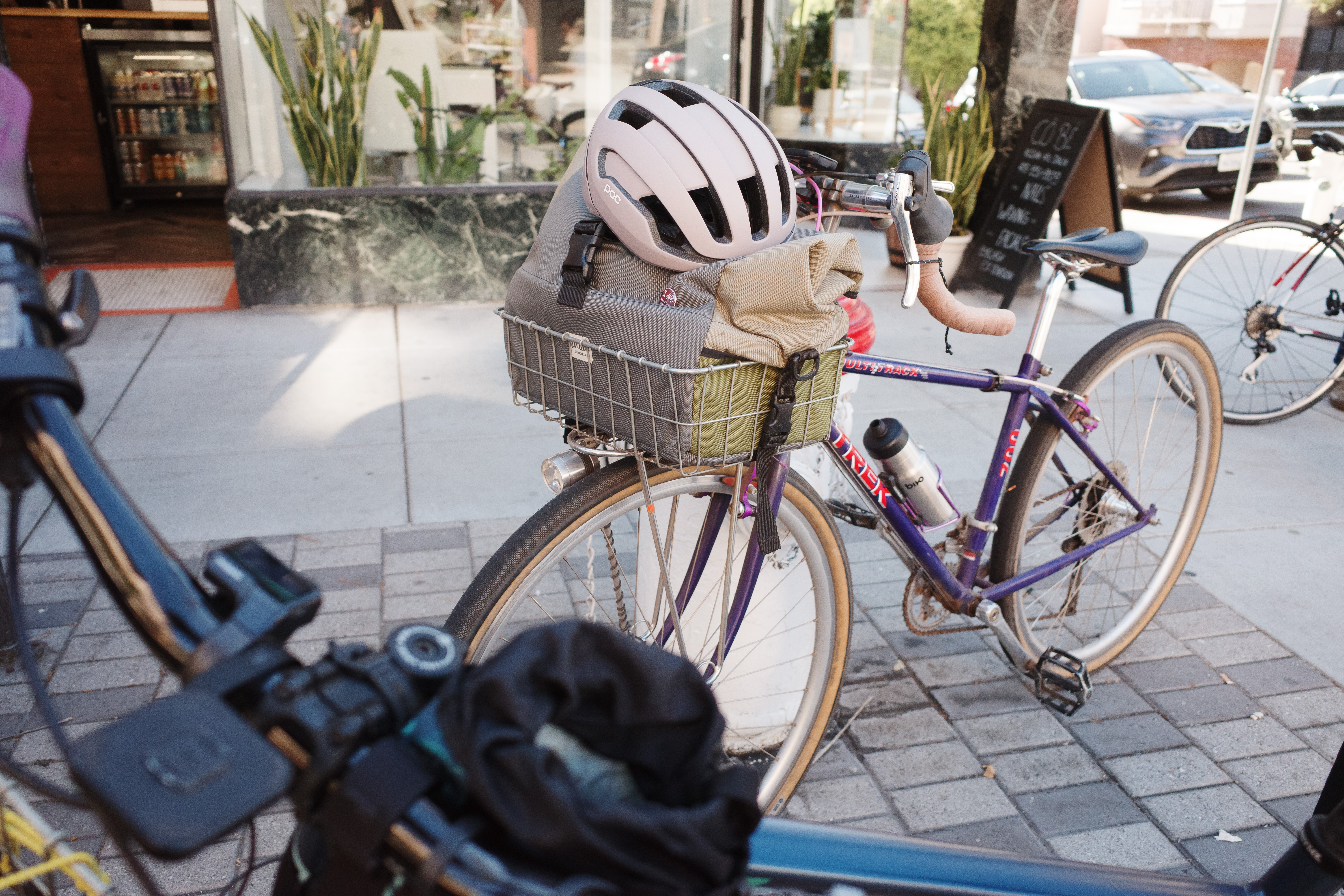 A purple vintage Trek mountain bike parked against a fire hydrant